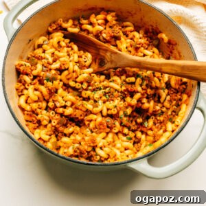 Hearty American Macaroni Bake 9 American Goulash recipe in a pot with a spoon.