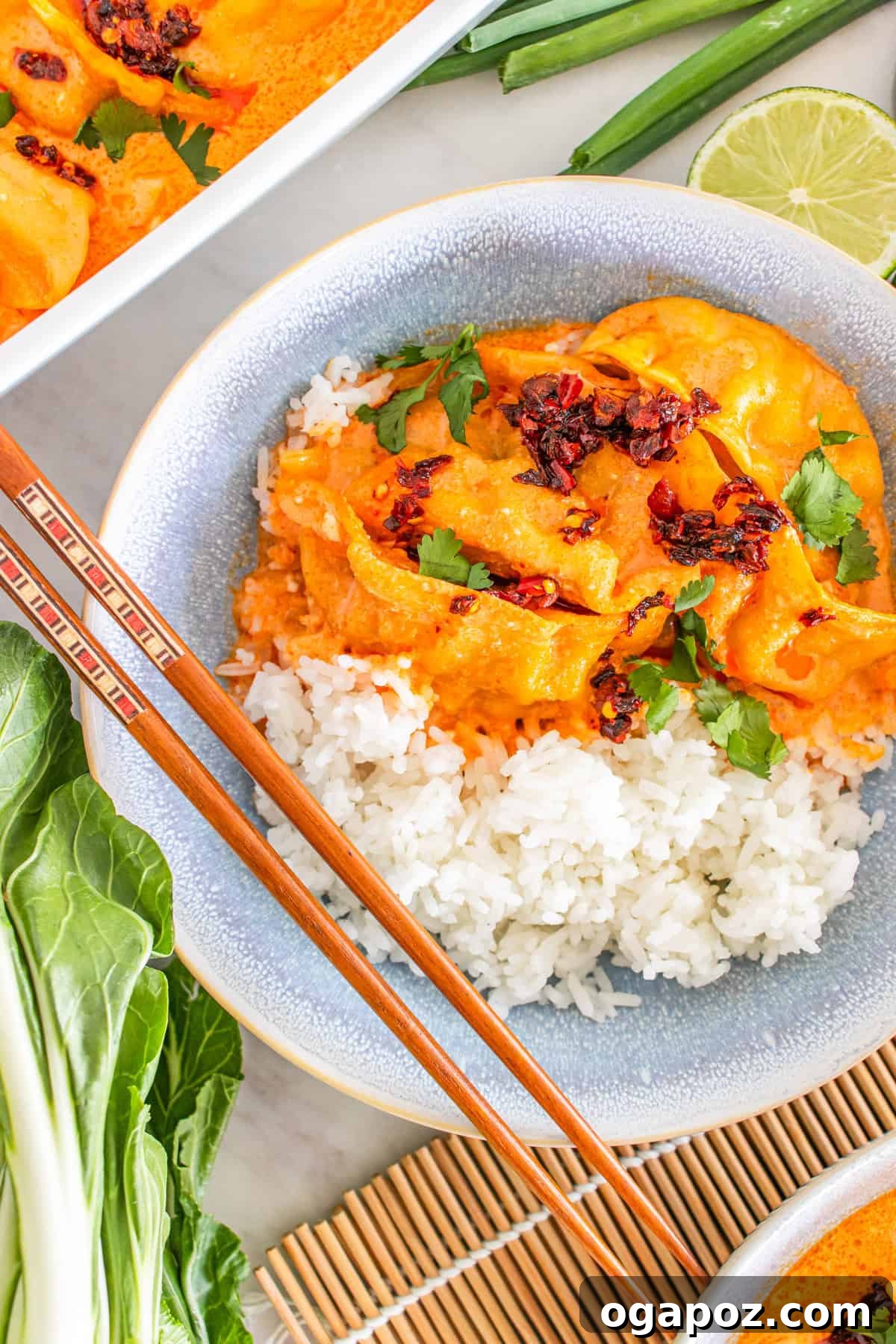 Savory One Pan Dumpling Bake 2 TikTok dumpling bake with coconut curry sauce featuring golden-brown dumplings, tender bok choy, and a rich, creamy sauce, garnished with fresh herbs and chili crisp.