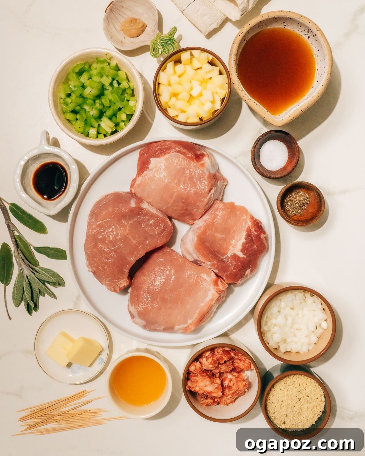 Signature Stuffed Pork Chops with an Unforgettable Pan Sauce 3 A flat lay of all the fresh ingredients needed for making stuffed pork chops, including pork chops, sausage, apples, onions, celery, sage, and various liquids and seasonings.