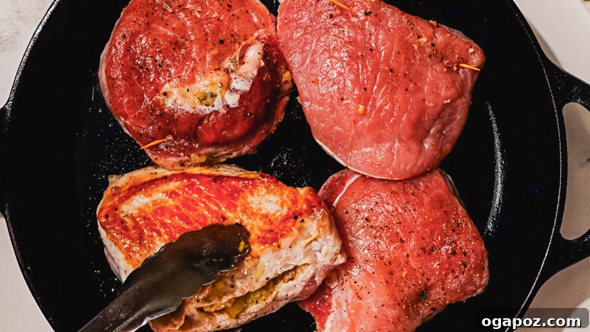 Signature Stuffed Pork Chops with an Unforgettable Pan Sauce 7 Step 4: Searing stuffed pork chops in an oven-safe skillet to create a golden crust.
