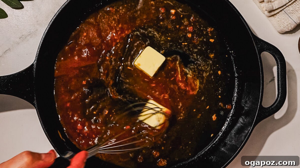Signature Stuffed Pork Chops with an Unforgettable Pan Sauce 8 Step 5: The stuffed pork chops baking in an oven-safe skillet, cooking to perfection.