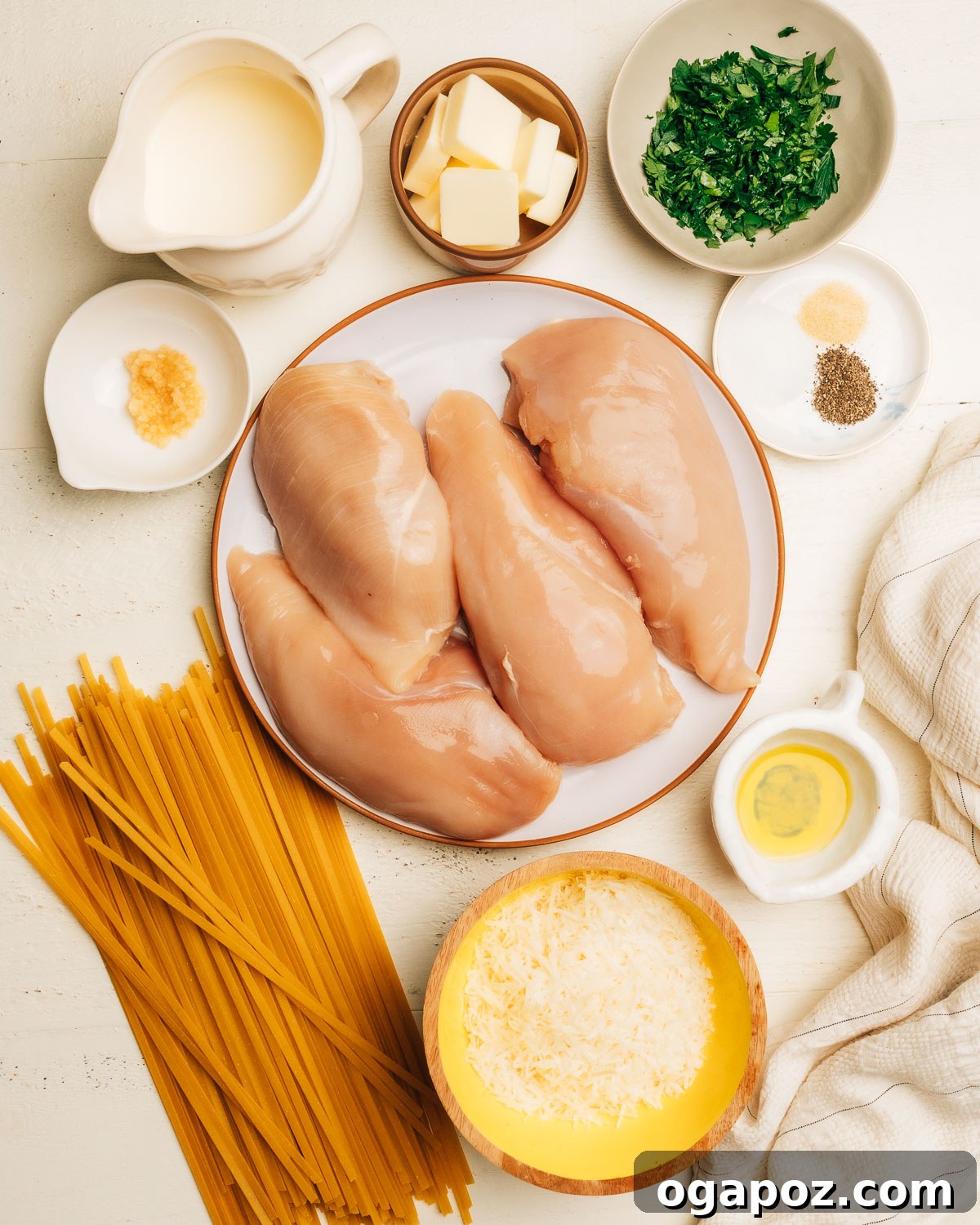 Rich and Creamy Chicken Alfredo 3 All ingredients for Chicken Alfredo recipe carefully laid out on a kitchen counter.