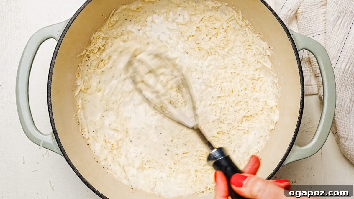 Rich and Creamy Chicken Alfredo 5 Whisking freshly grated parmesan cheese into a simmering cream sauce for smooth alfredo.