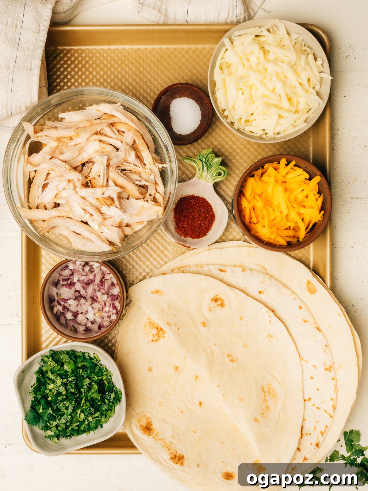 Ultimate Chicken Quesadilla 3 Chicken quesadilla ingredients laid out on a kitchen counter, ready for preparation.