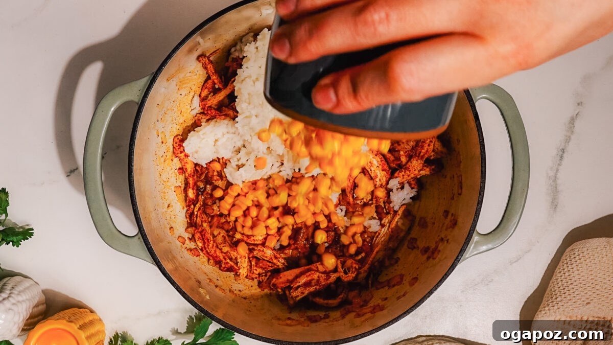 Fiesta Chicken Bake 6 Step 3: Season shredded chicken with chili powder in the skillet.