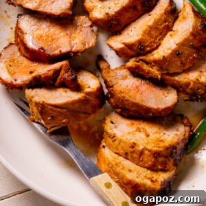Sliced marinated Pork Tenderloin recipe on a plate, ready to serve.