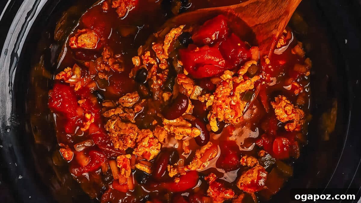 Step 5: The crockpot simmering, cooking the turkey chili slowly to perfection.