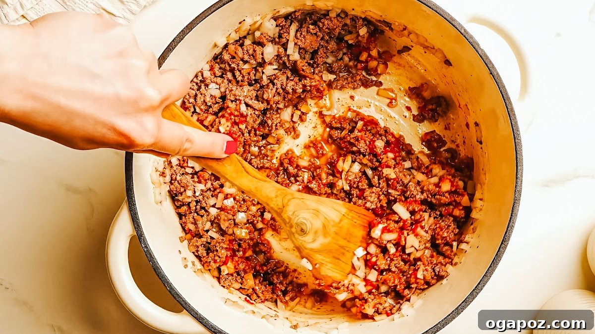 Creamy Ricotta Baked Ziti 5 Ground beef searing in a Dutch oven, achieving deep caramelization for maximum flavor in the baked ziti.