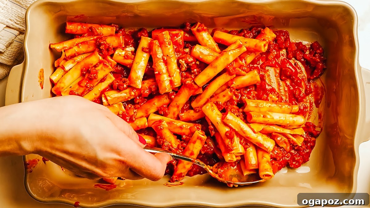 Creamy Ricotta Baked Ziti 7 Tomato paste caramelizing in the pot, developing deep umami notes before being mixed into the meat sauce.