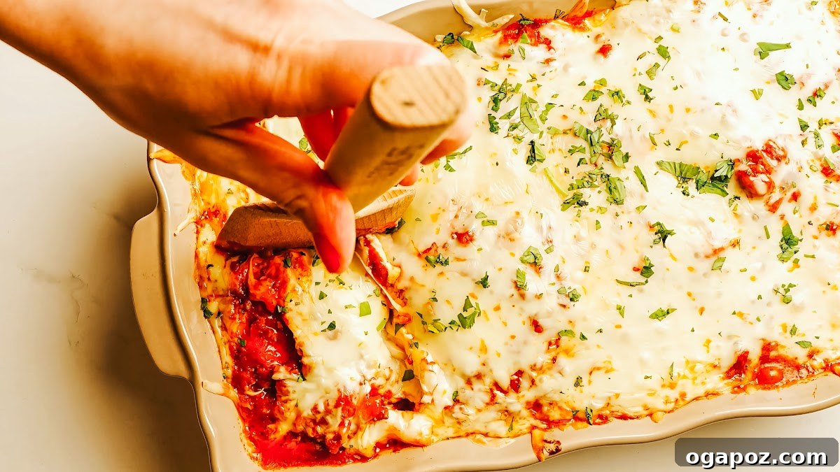 Creamy Ricotta Baked Ziti 9 Layered baked ziti casserole, showcasing the pasta, ricotta, and meat sauce before the final cheese topping is added.