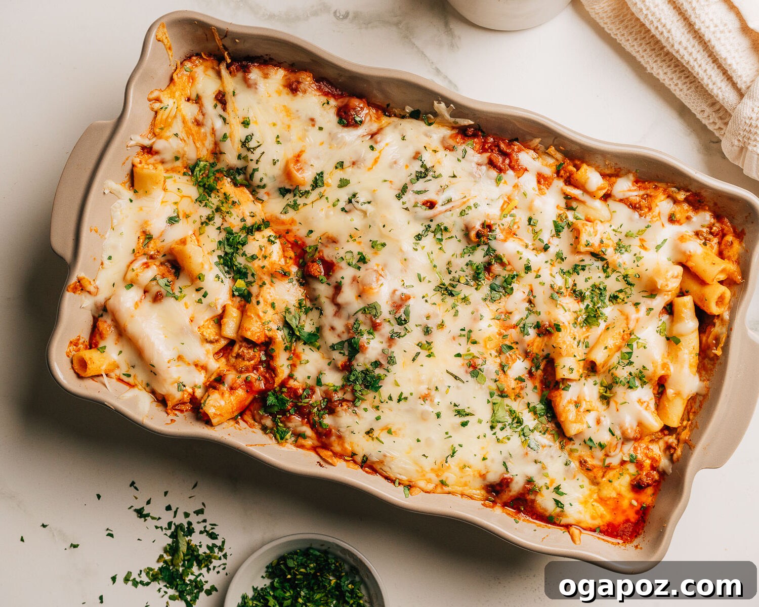 Creamy Ricotta Baked Ziti 10 Baked ziti with ricotta topped with minced parsley, showcasing the delicious golden crust and creamy layers within.