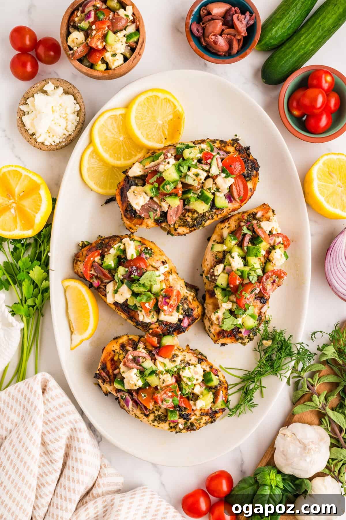 Plated grilled Mediterranean chicken breast with a generous drizzle of herb marinade and a fresh feta topping.