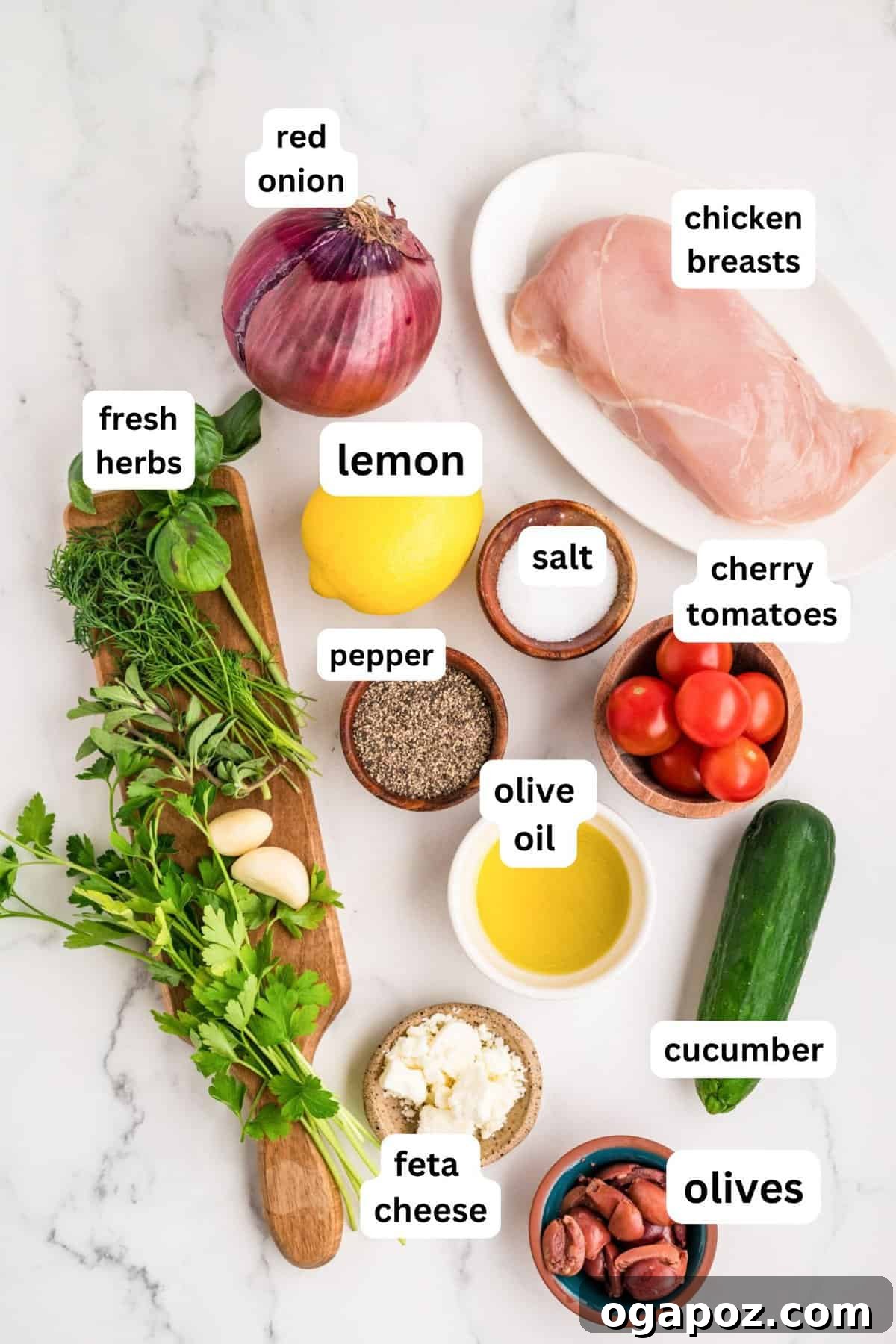 Fresh ingredients laid out for grilled Mediterranean chicken marinade: bright yellow lemons, rich olive oil, vibrant fresh parsley, feathery dill, fragrant oregano, and aromatic basil.