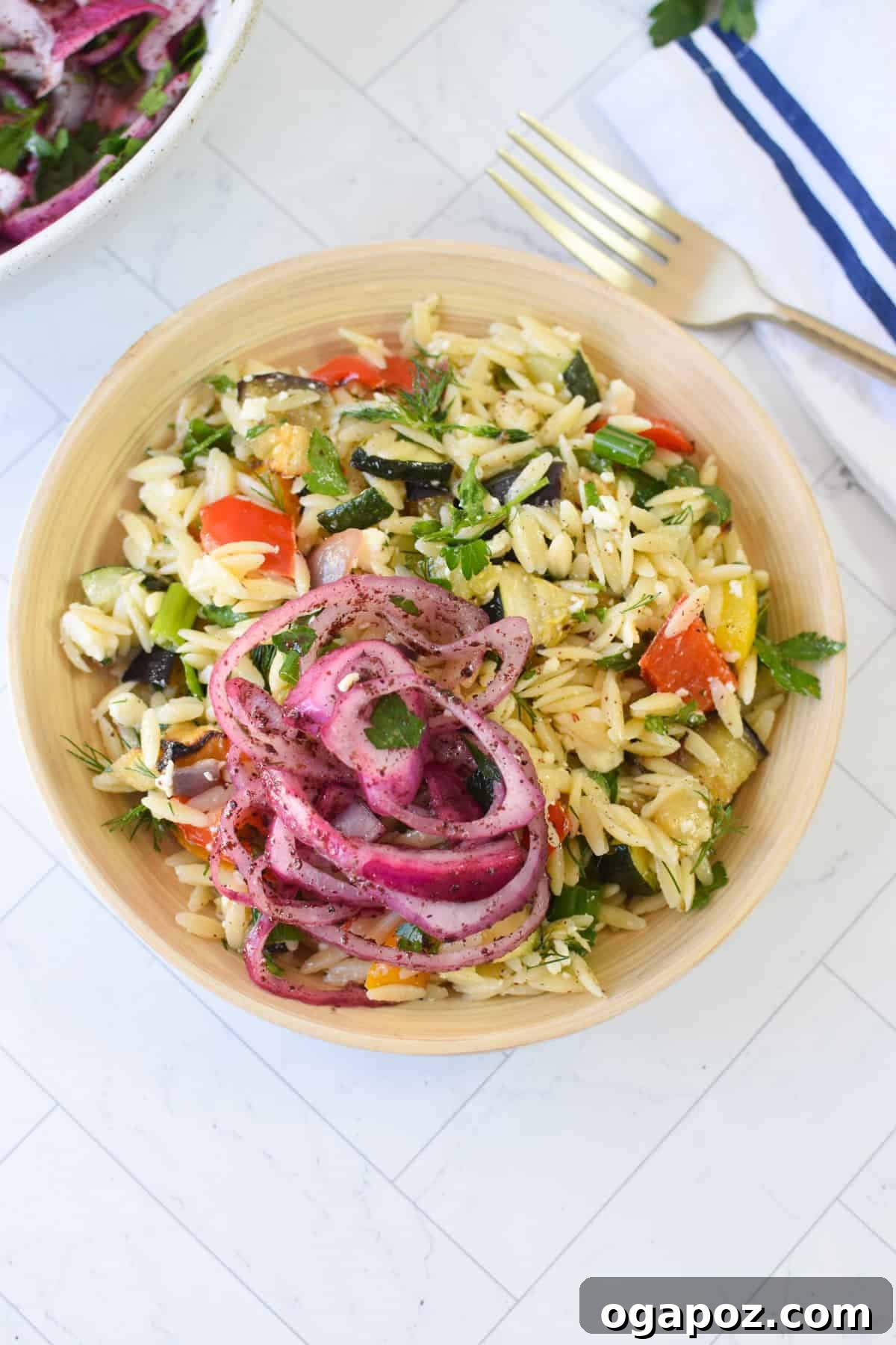 Mediterranean Roasted Vegetable Orzo Salad with Feta 6 Mediterranean roasted vegetable orzo salad with crumbled feta and lemon herb dressing, ready to be served