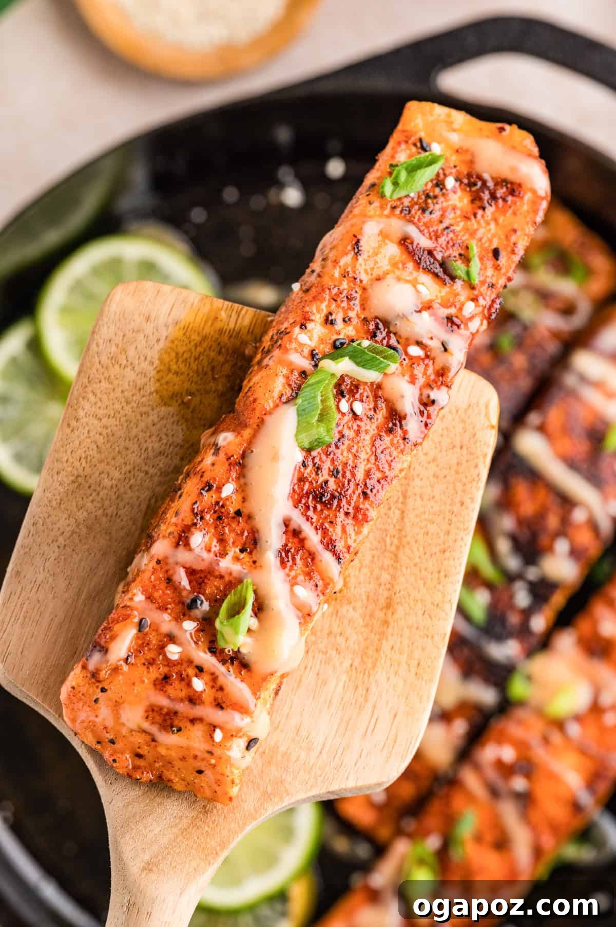Dynamite Salmon 6 Bang bang salmon with sauce being drizzled over golden seared fillets on a spatula