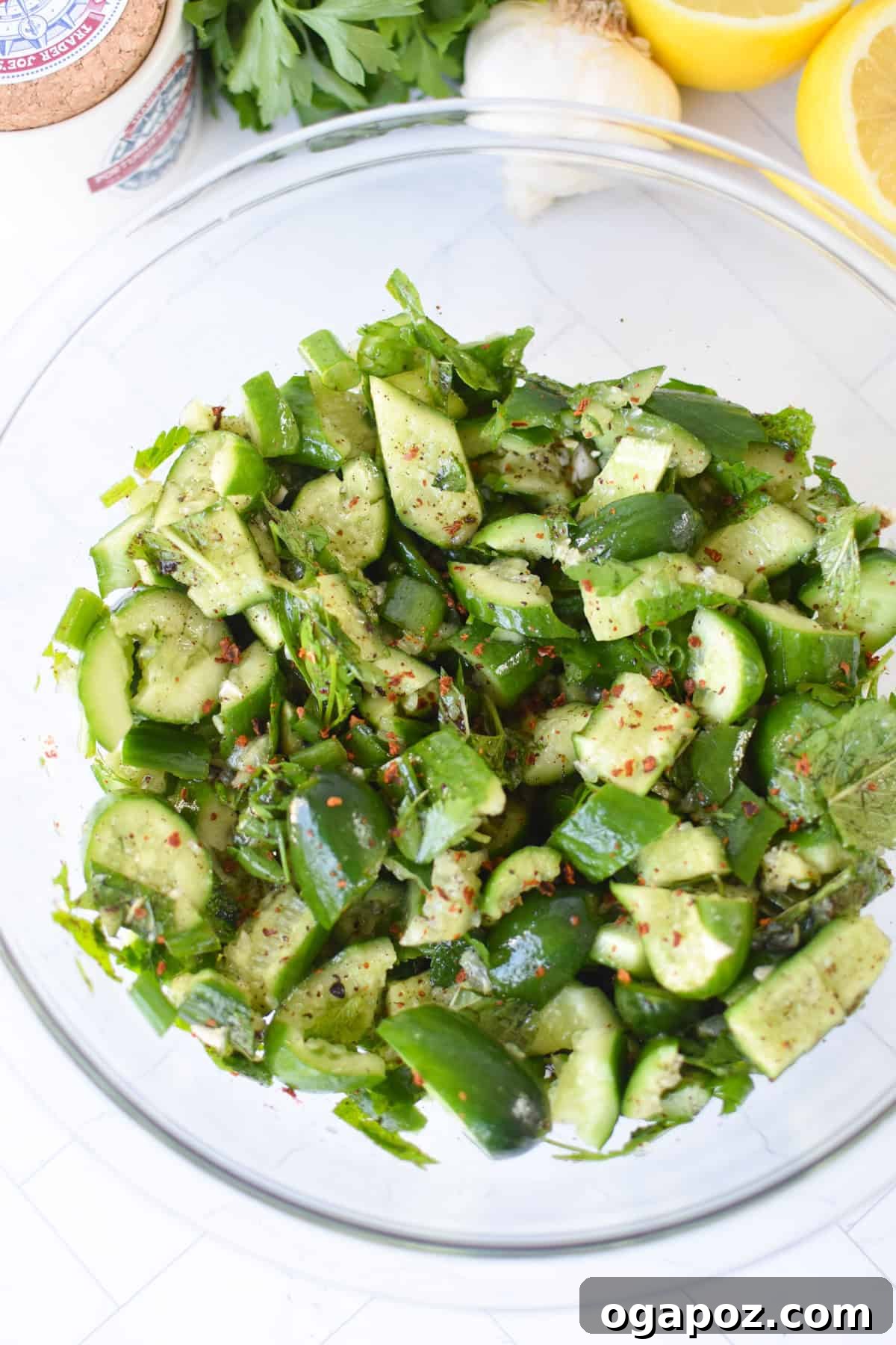 A close-up shot of the finished Smashed Cucumber Salad with Sumac, Mint, and Lemon, ready to be served.