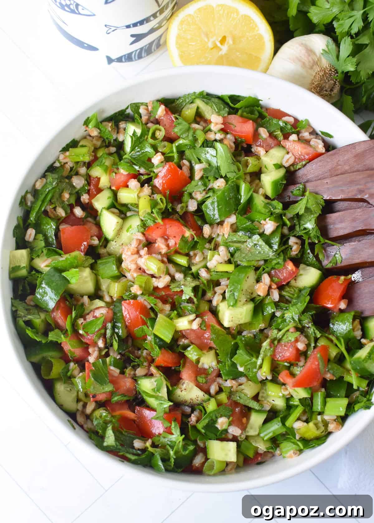 Vibrant Farro Tabbouleh 2 A vibrant and hearty Farro Tabbouleh Salad, garnished with fresh parsley and crumbled feta, served in a white ceramic bowl.
