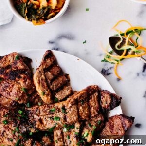 Korean-Style Grilled Short Ribs (Galbi) Recipe 4 Grilled Korean Short Ribs on a plate with green onion garnish.