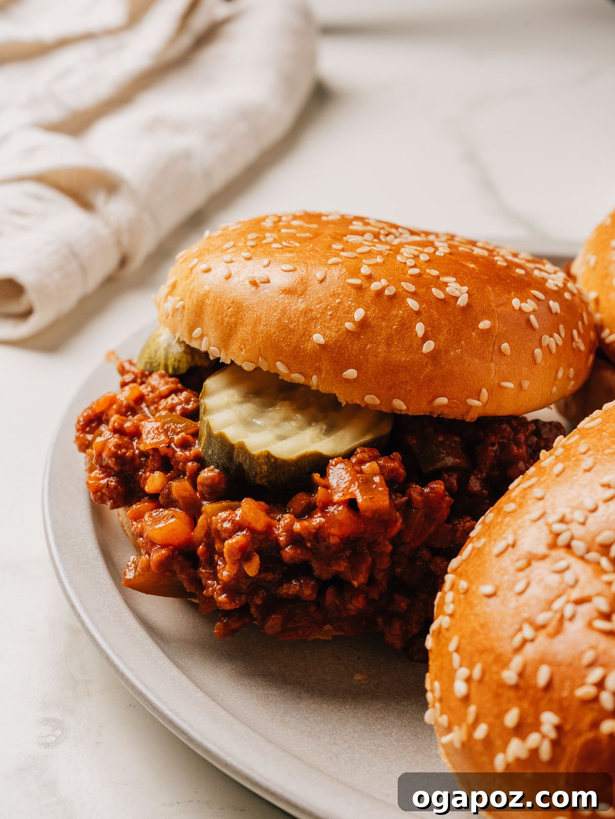 Classic Sloppy Joes Recipe: Savory Ground Beef Sandwiches 4 Easy sloppy joes recipe in a bun on a plate.