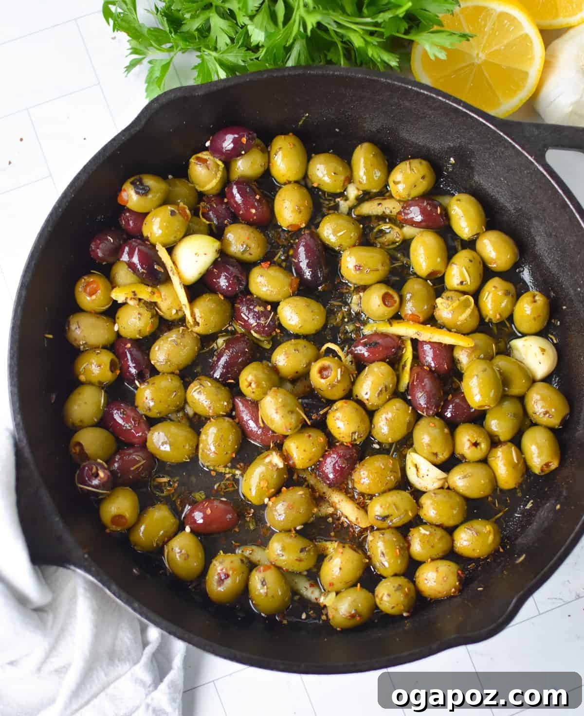 Warm Lemon-Herb Olives with Mediterranean Spices — 10-Minute Appetizer 8 Warm Olives with Mediterranean Herbs in a Cast Iron Skillet