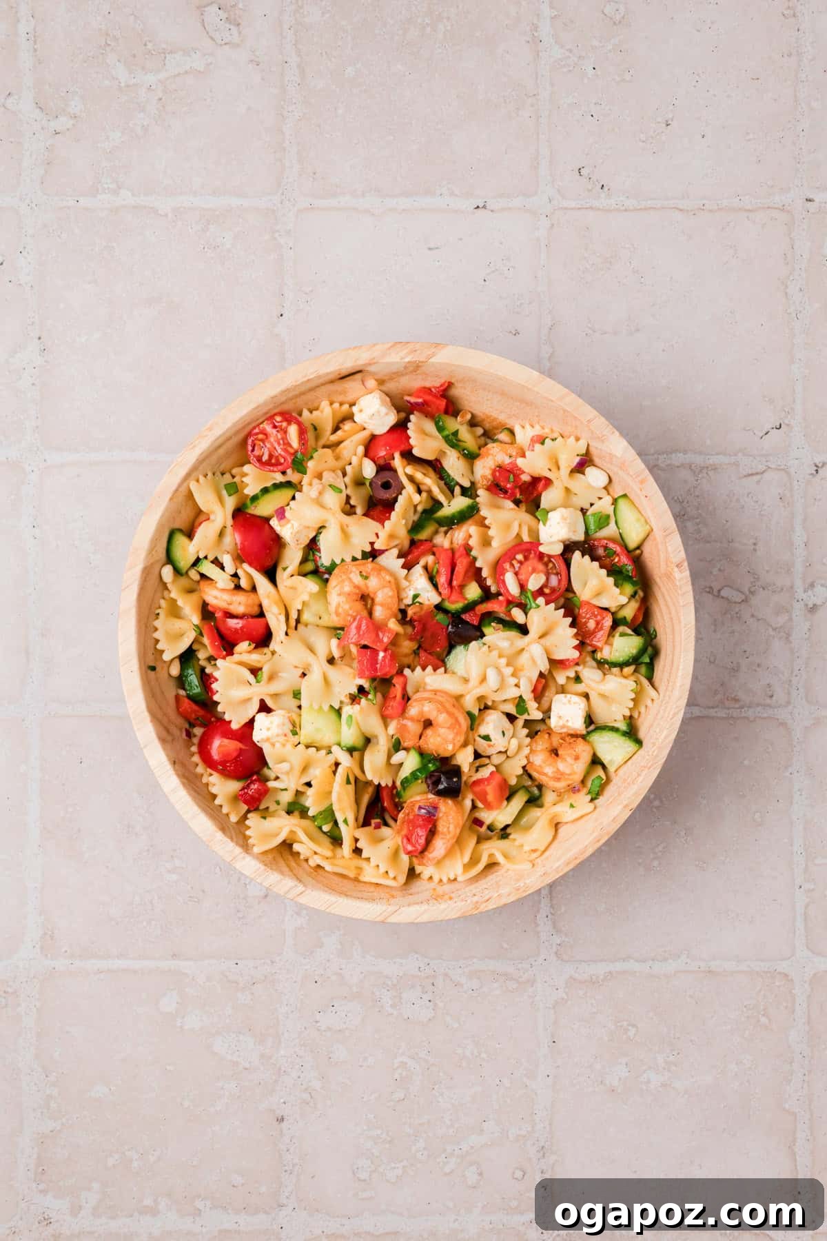 Make-Ahead Mediterranean Shrimp Pasta Salad for Summer Meals 10 Close up of shrimp pasta salad with toasted pine nuts, Kalamata olives, and feta