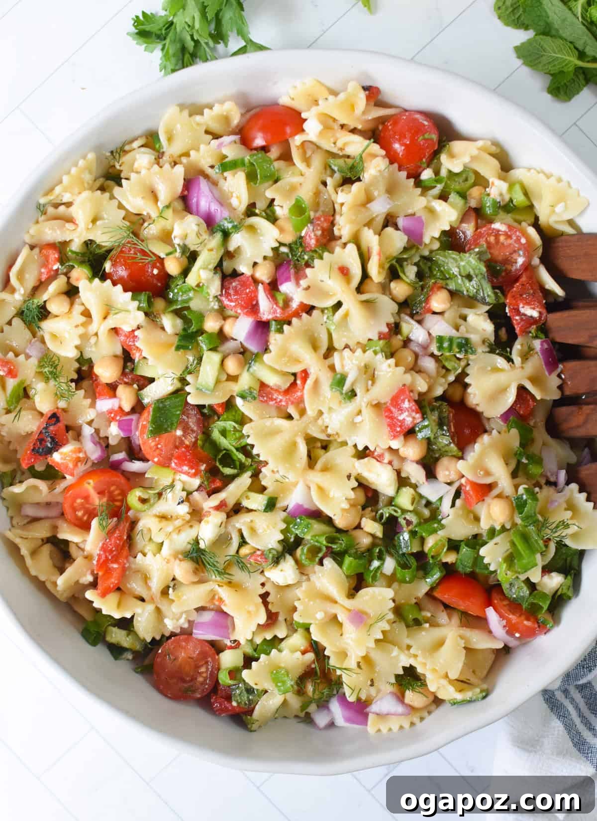 Mediterranean Bow-Tie Pasta Salad with Feta & Olives 2 Mediterranean bow tie pasta salad in a large serving bowl with feta and fresh herbs