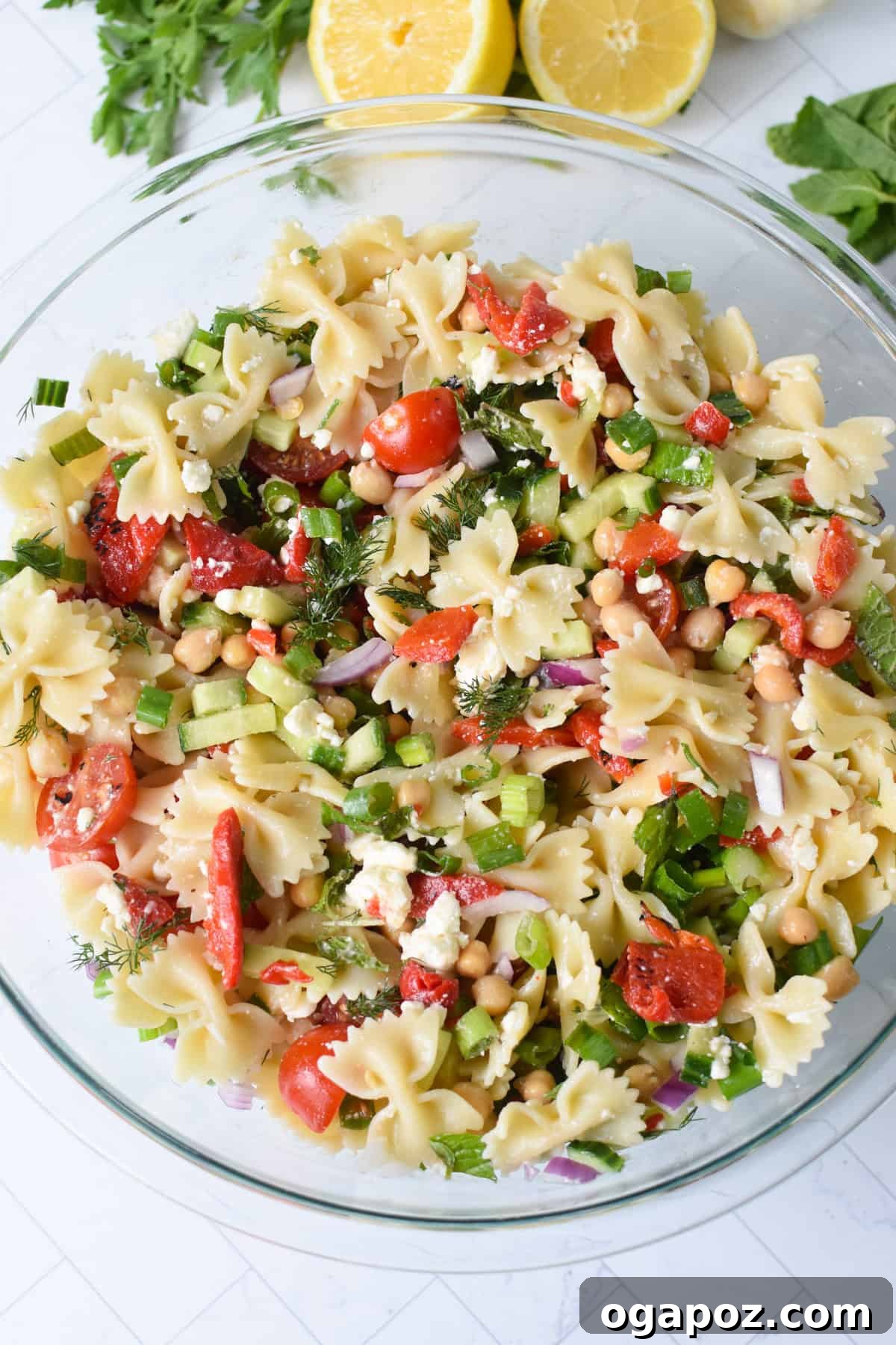 Mediterranean Bow-Tie Pasta Salad with Feta & Olives 9 Easy Mediterranean Bowtie Pasta Salad in a glass bowl