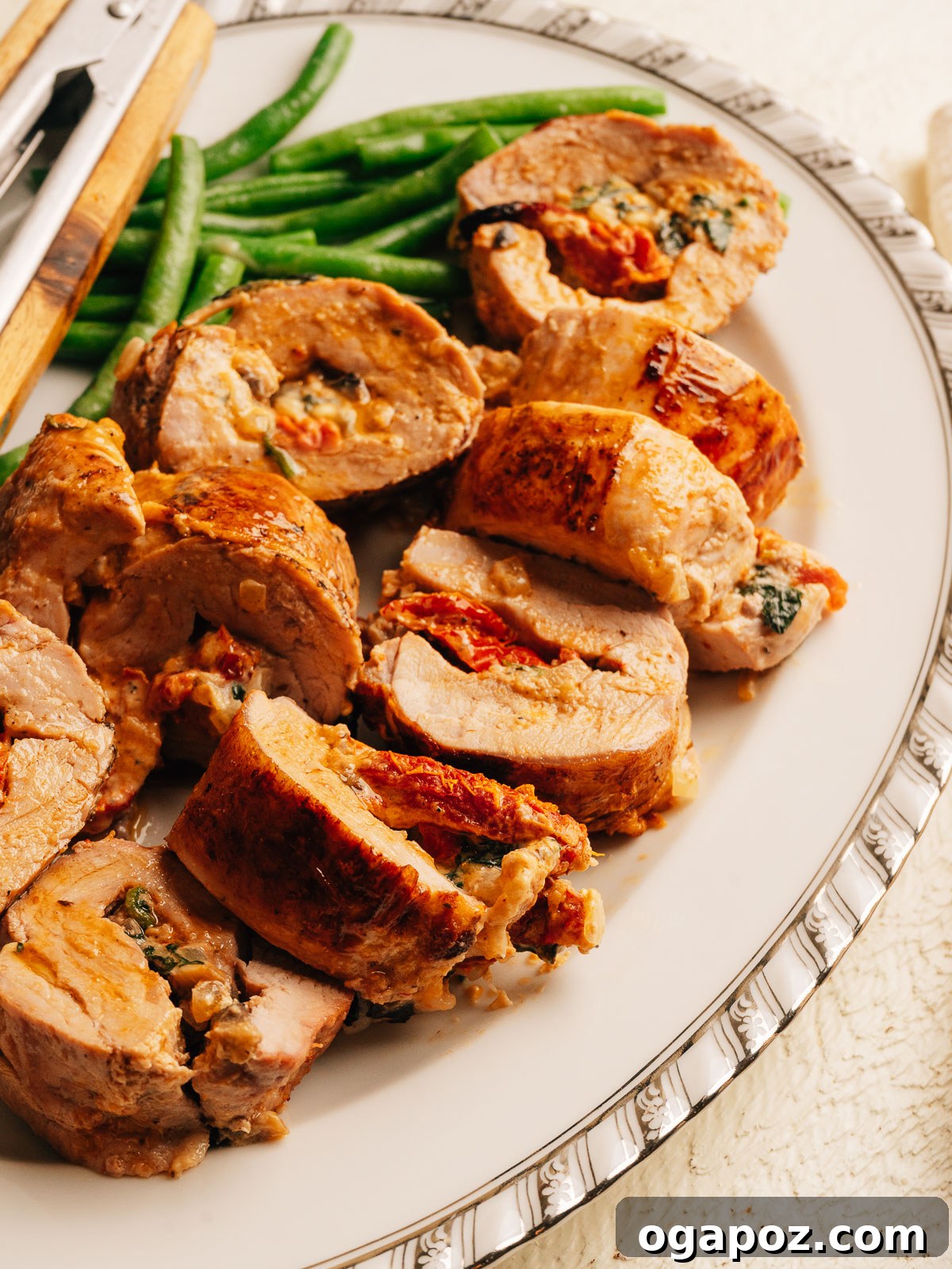Mediterranean Stuffed Pork Tenderloin with Creamy Feta Filling 11 Sliced stuffed pork tenderloin showing creamy sun-dried tomato and spinach filling.
