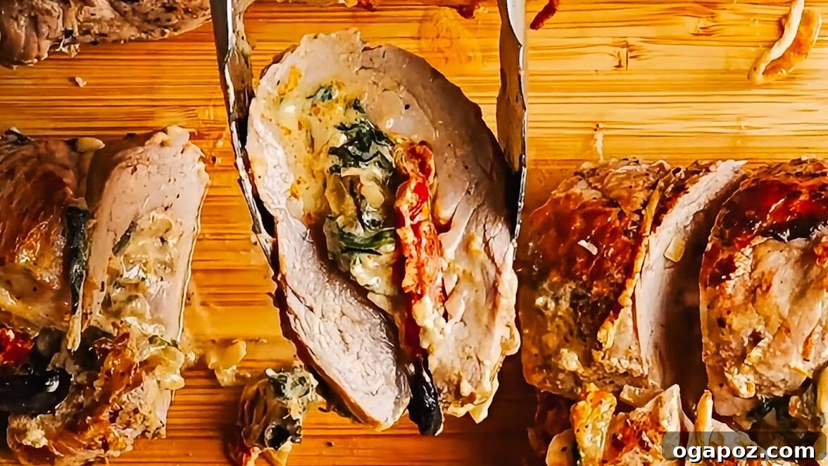 Mediterranean Stuffed Pork Tenderloin with Creamy Feta Filling 12 Slicing a stuffed pork tenderloin into rounds after roasting.