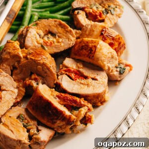 Mediterranean Stuffed Pork Tenderloin with Creamy Feta Filling 13 Sliced stuffed pork tenderloin showing creamy sun-dried tomato and spinach filling.