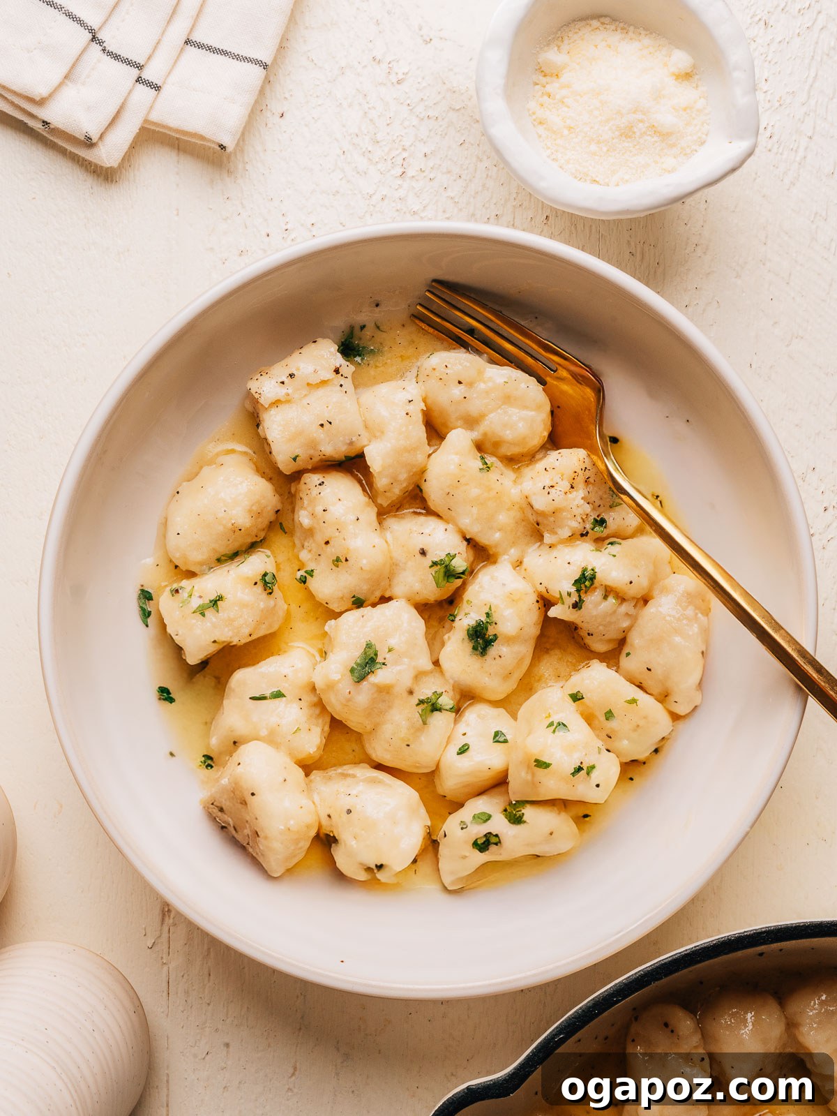 Homemade Potato Gnocchi Recipe from Scratch: Soft & Fluffy 2 Bowl of homemade potato gnocchi in butter sauce with parmesan and fresh parsley.