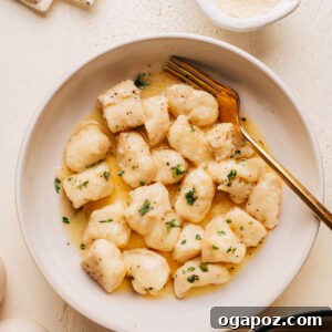 Homemade Potato Gnocchi Recipe from Scratch: Soft & Fluffy 13 Bowl of homemade potato gnocchi in butter sauce with parmesan and fresh parsley.