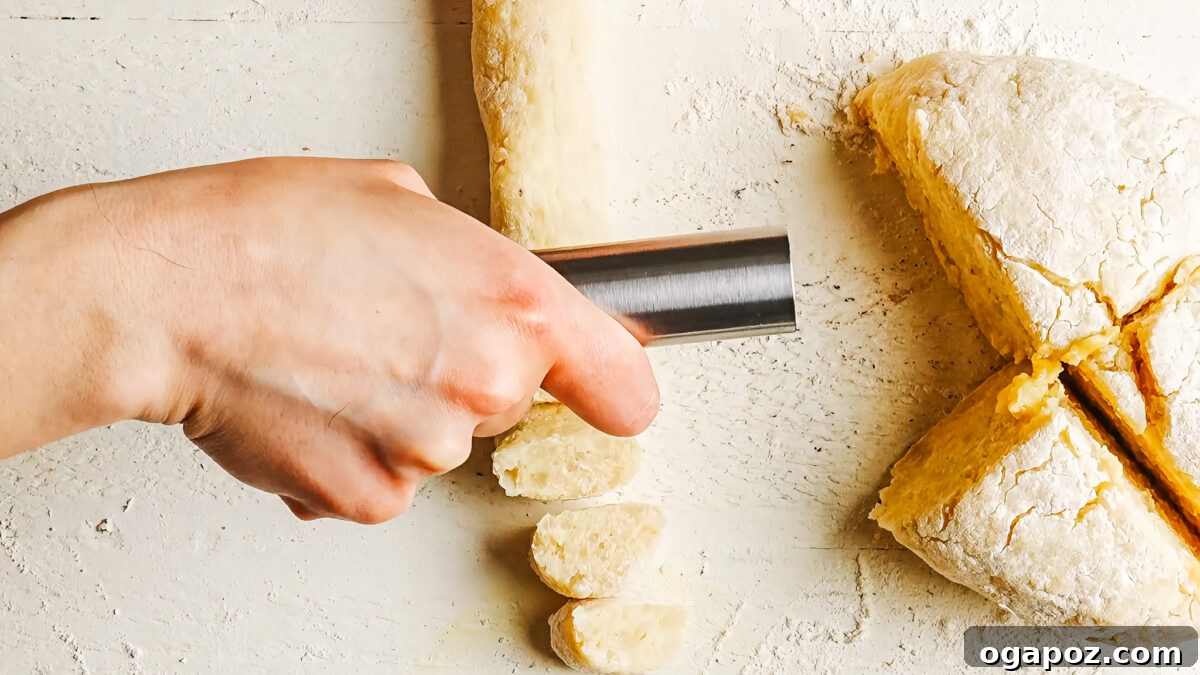 Homemade Potato Gnocchi Recipe from Scratch: Soft & Fluffy 8 Rolling gnocchi dough into a rope and cutting it into bite-sized pieces