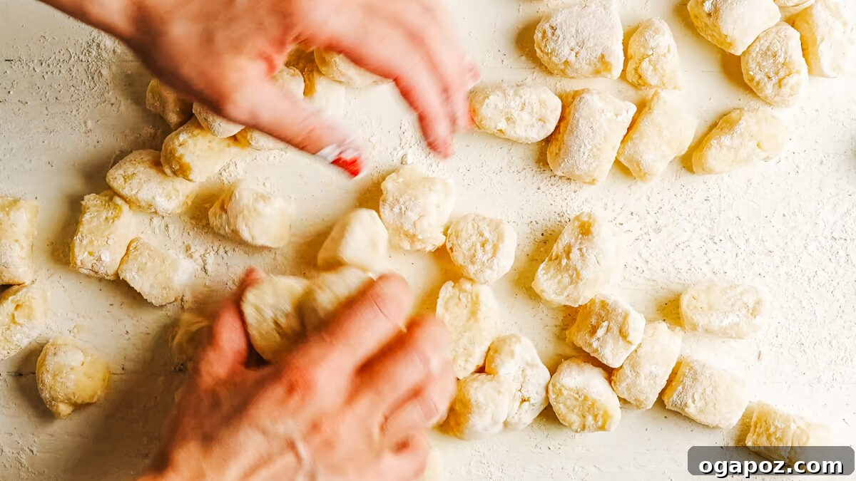 Homemade Potato Gnocchi Recipe from Scratch: Soft & Fluffy 9 Shaping each gnocchi by rolling it along the tines of a fork to form ridges