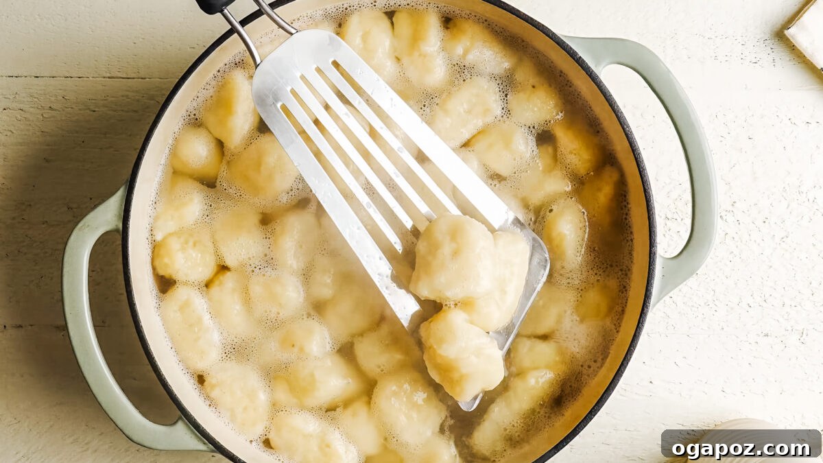Homemade Potato Gnocchi Recipe from Scratch: Soft & Fluffy 10 Cooked potato gnocchi floating in a pot of boiling water