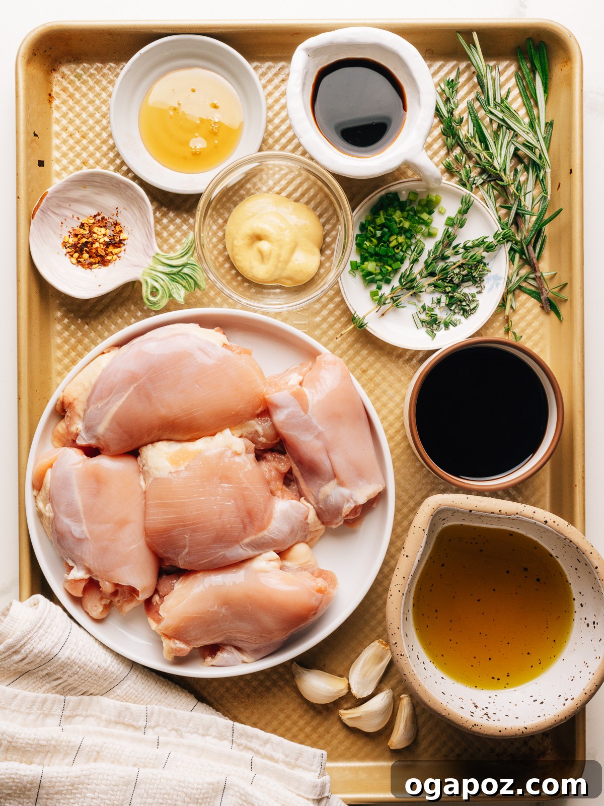 Marinated Grilled Boneless Chicken Thighs Juicy Every Time 3 Ingredients for grilled boneless chicken thighs laid out on a sheet pan.