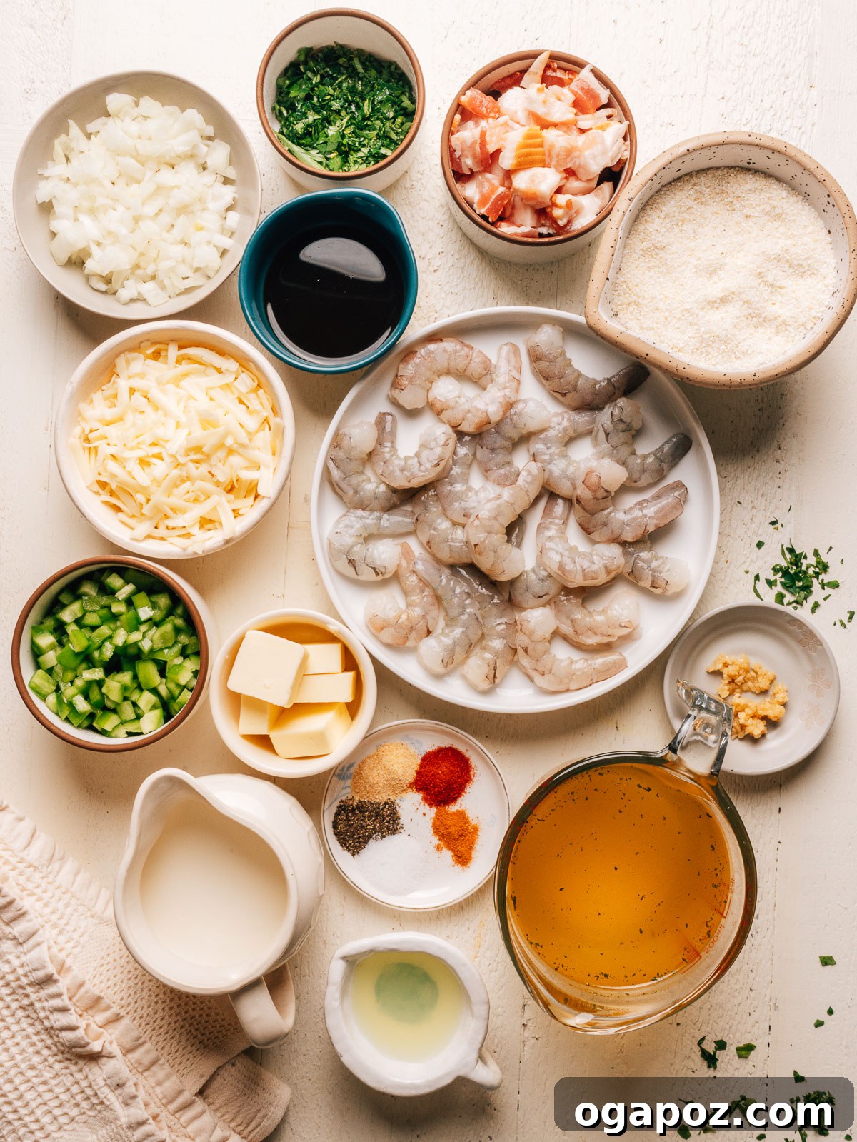 Creamy Southern Shrimp and Grits Recipe for Weeknight Dinner 3 Ingredients for shrimp and grits laid out in bowls, including raw shrimp, grits, cheddar, bacon, onion, and bell pepper.