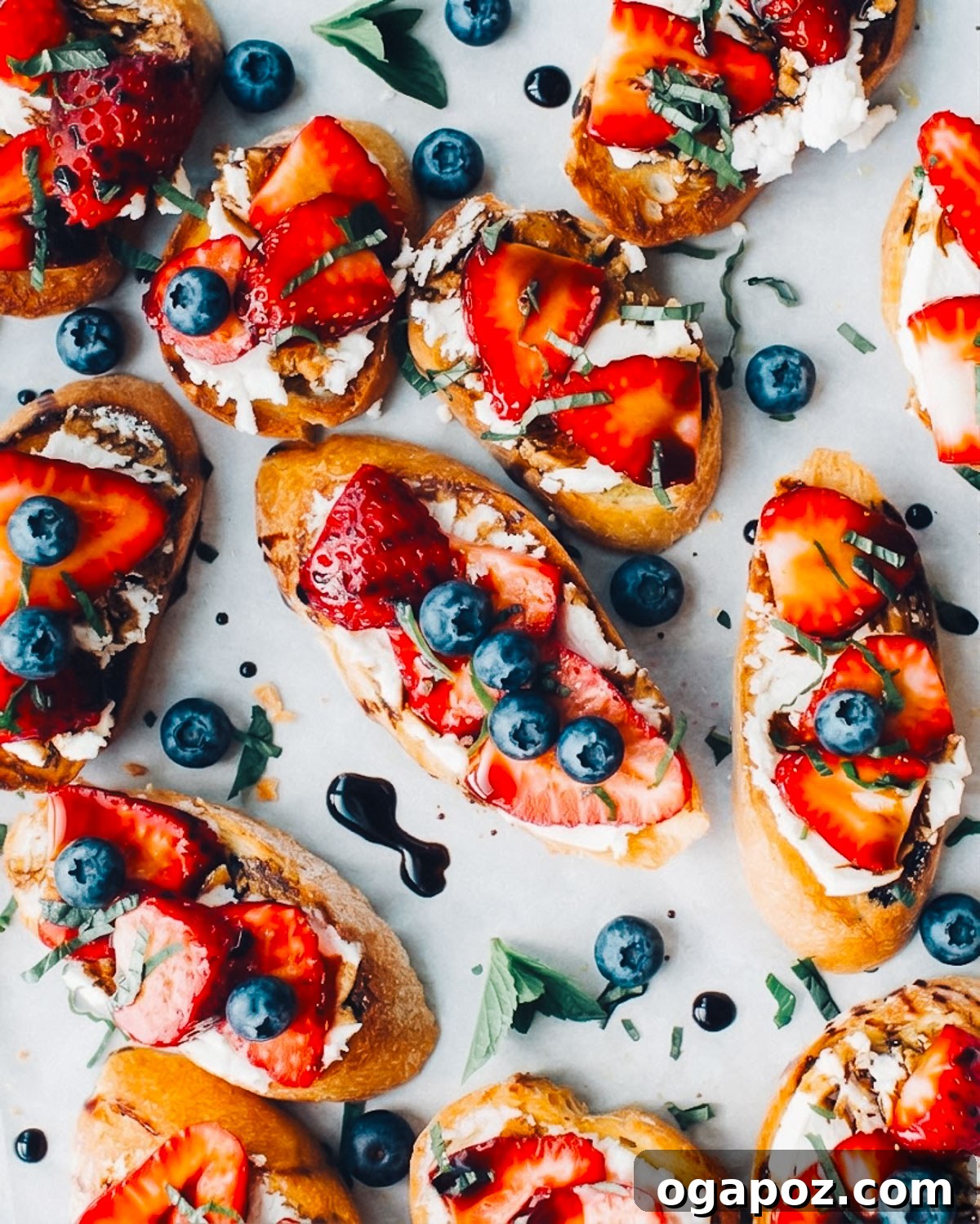 Quick Fourth of July Recipes for Your Independence Day Menu 2 Red, white and blue 4th of july crostini appetizers on a tray with blueberries and strawberries.