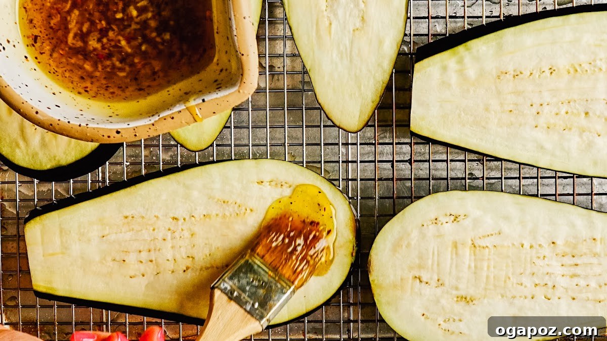Grilled Eggplant with Garlic Oil and Whipped Feta 7 Brushing garlic oil over eggplant slices on a rack.