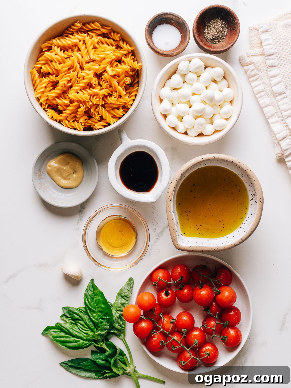 Caprese Pasta Salad with Cherry Tomatoes, Mozzarella & Basil 3 Caprese pasta salad ingredients on a countertop.