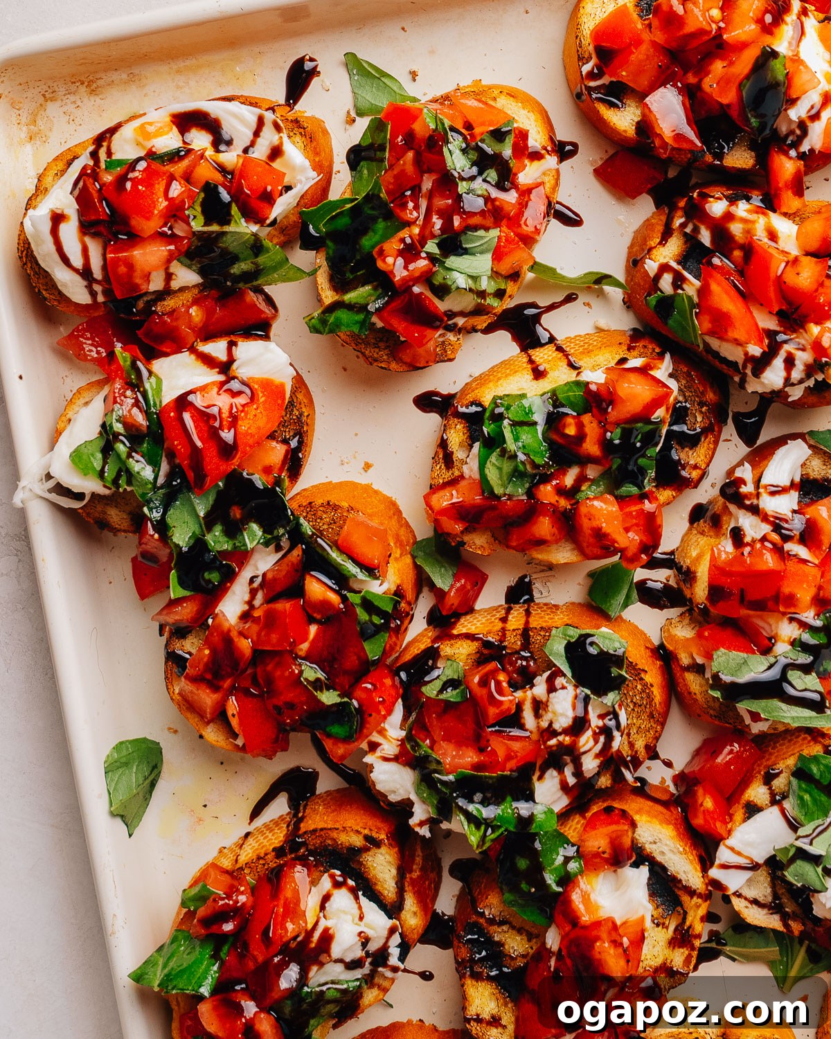 Fresh Mozzarella Bruschetta Recipe, Quick Appetizer 2 Overhead tray of bruschetta with mozzarella, tomato and basil.