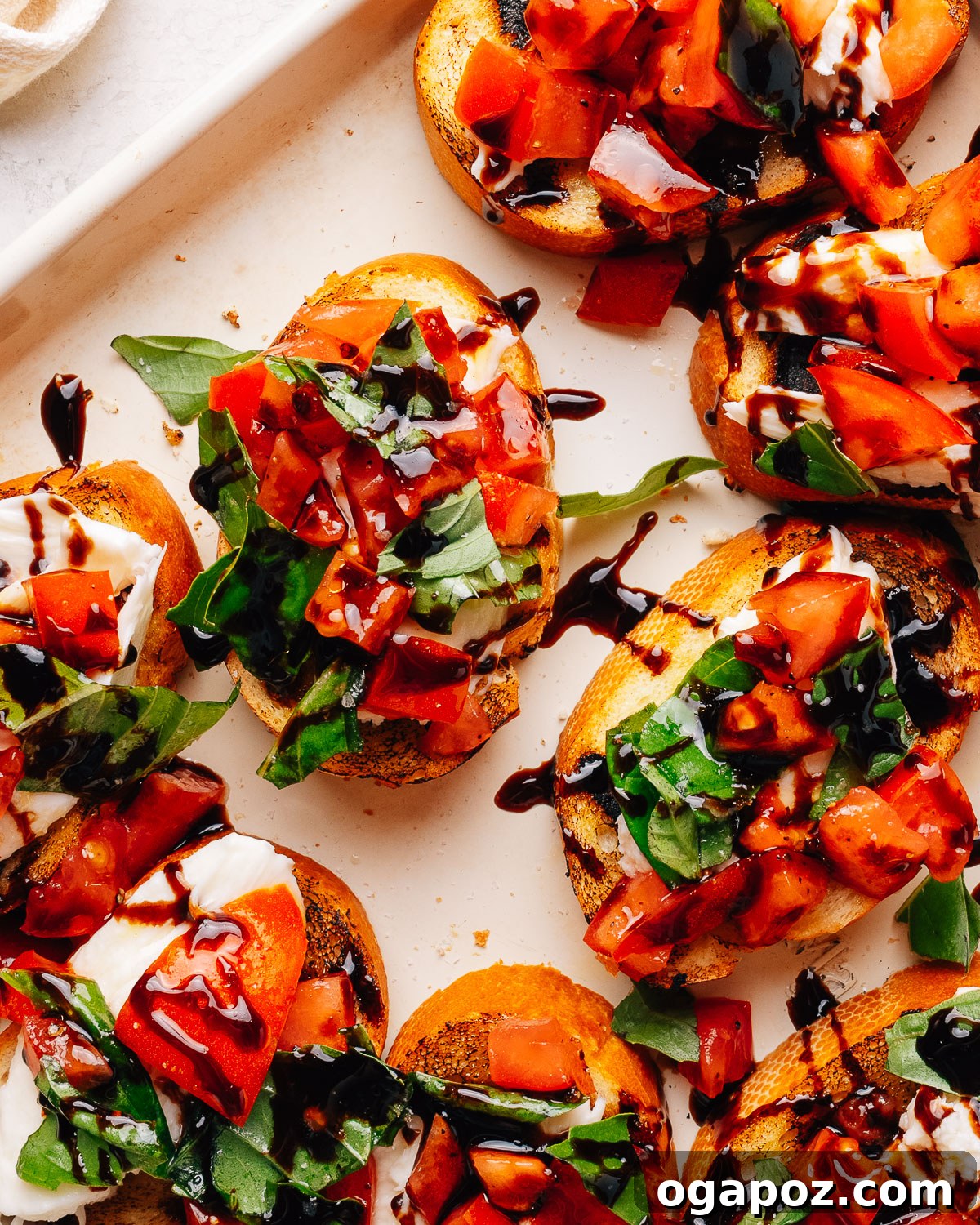 Fresh Mozzarella Bruschetta Recipe, Quick Appetizer 12 Overhead tray of bruschetta with mozzarella, tomato and basil.