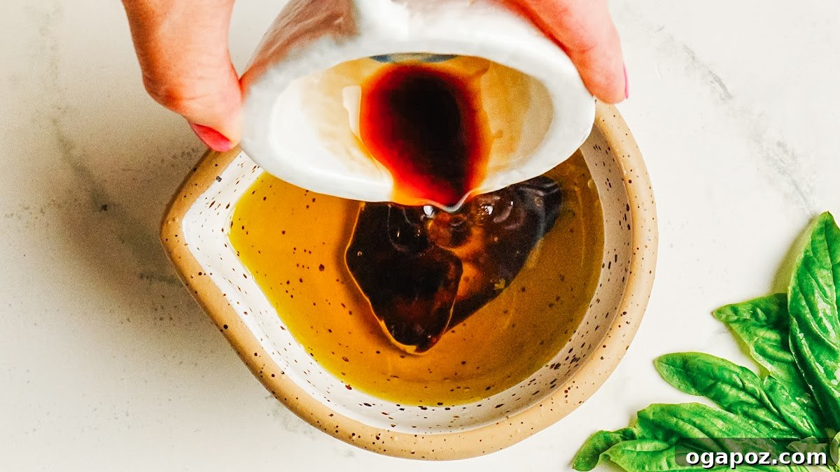 Classic Homemade Balsamic Vinaigrette Recipe 4 Pouring balsamic vinegar into olive oil to start the vinaigrette.