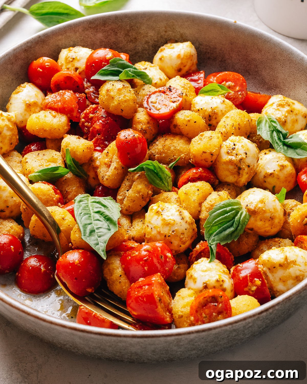 Crispy Gnocchi Caprese Salad with Fresh Pesto 8 Overhead bowl of crispy gnocchi salad tossed with pesto and cherry tomatoes.