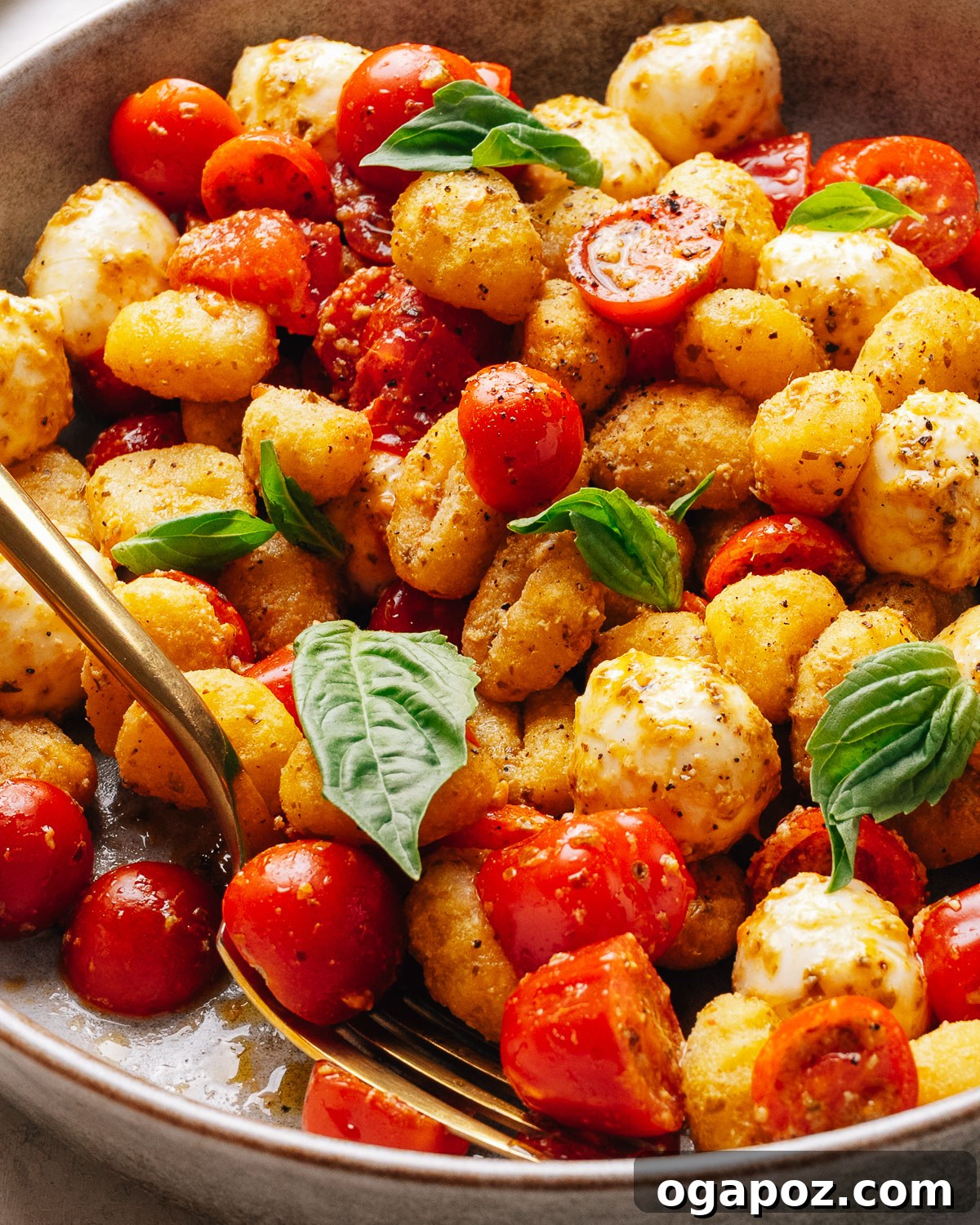Crispy Gnocchi Caprese Salad with Fresh Pesto 9 A plated portion of gnocchi salad with golden crisp gnocchi and fresh basil.