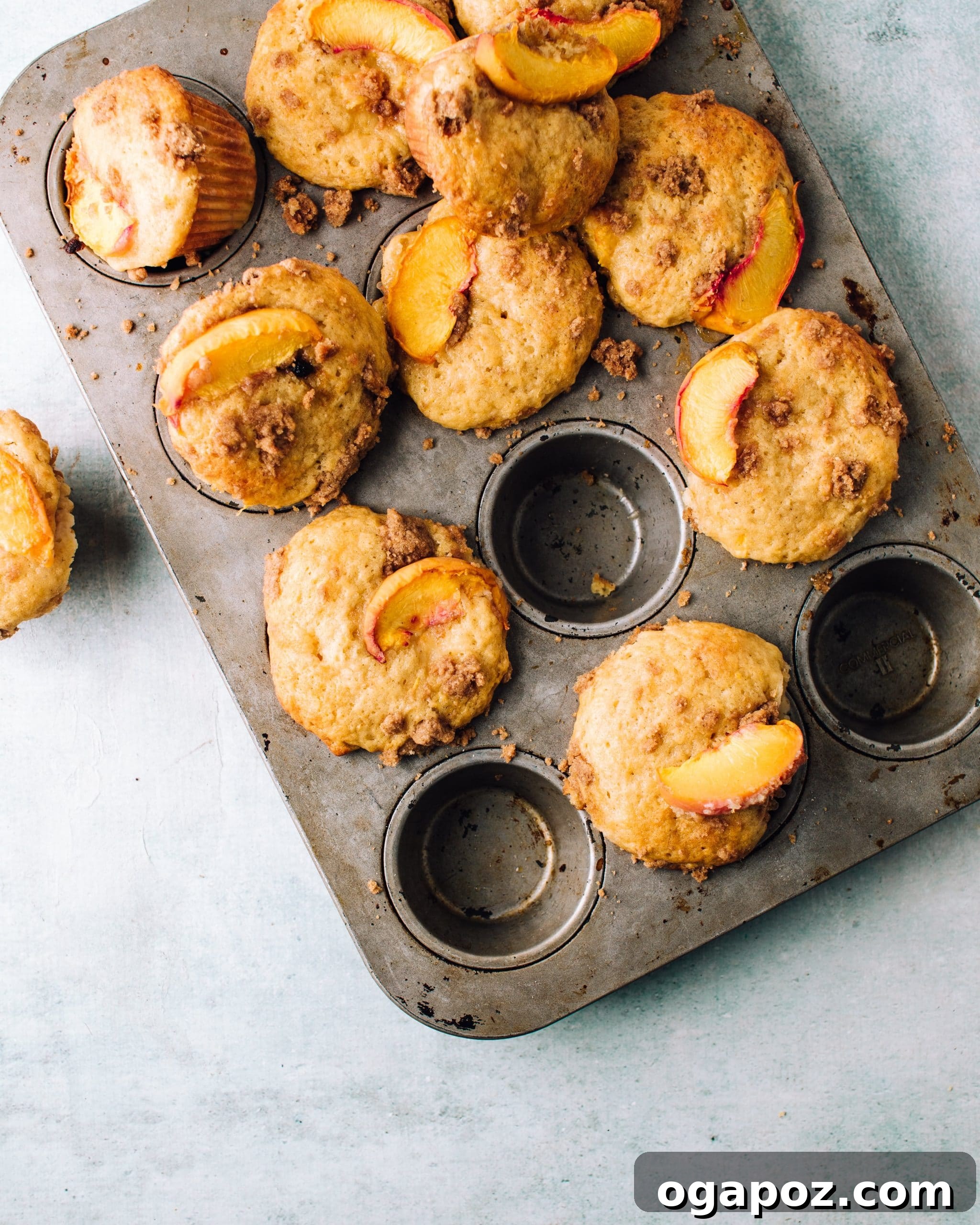 Summer Fruit Dessert Recipes: Peach, Cherry and Berries 4 Peach streusel muffins in a baking pan.