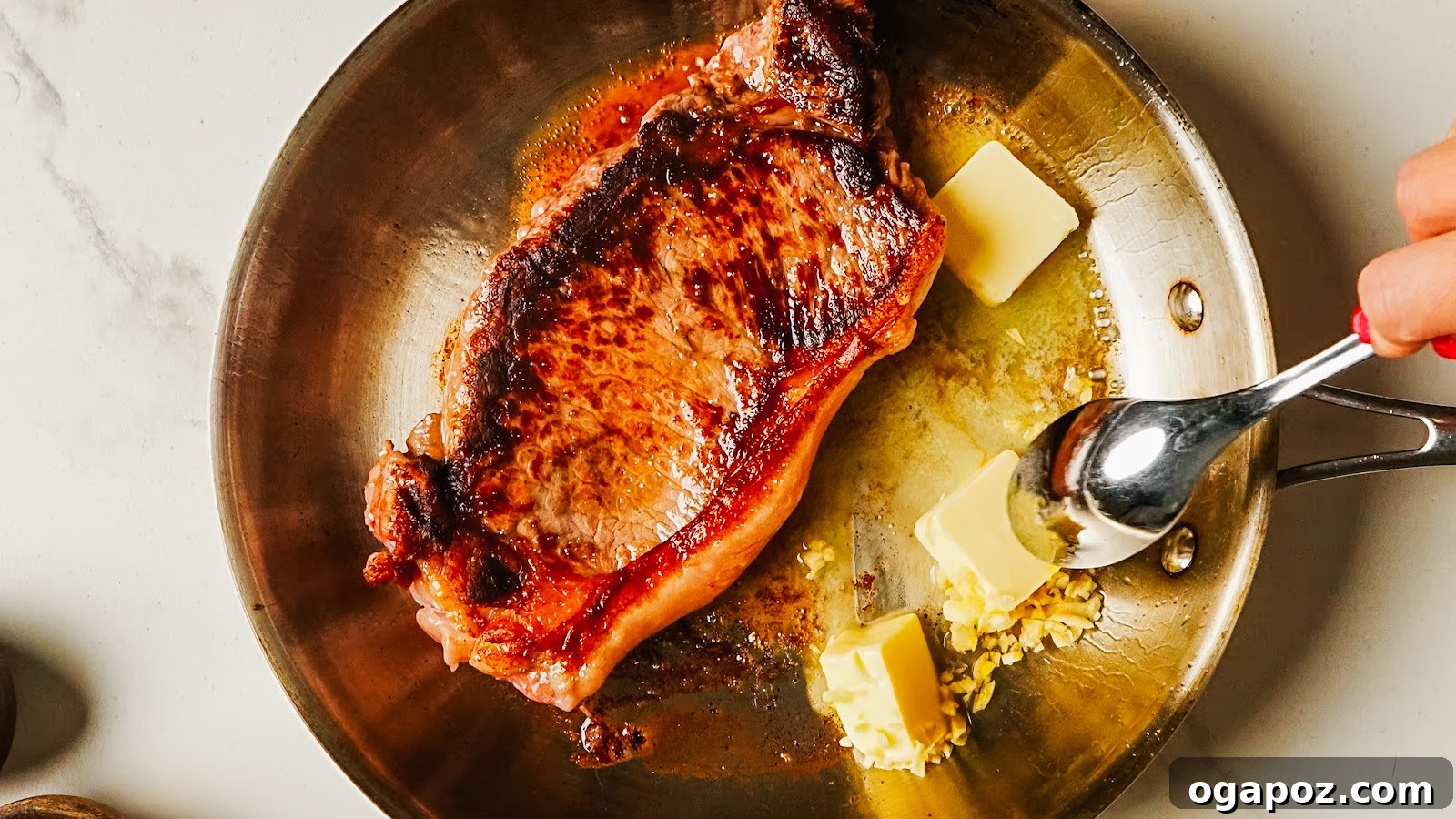 Pan-Seared Garlic Butter Steak Ready in 15 Minutes 6 Spooning foaming garlic butter over the steak in the pan.