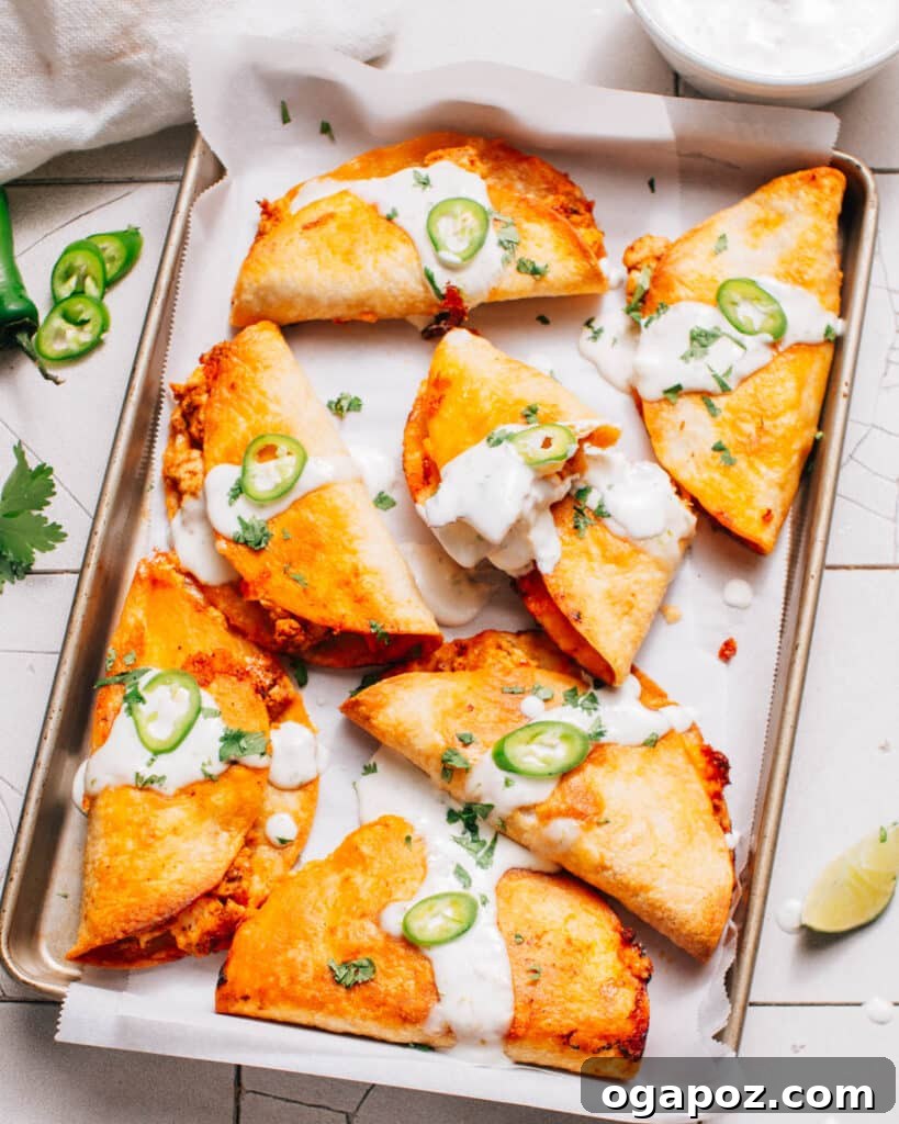 Crispy baked chicken tacos with melted cheese in crackly shells.