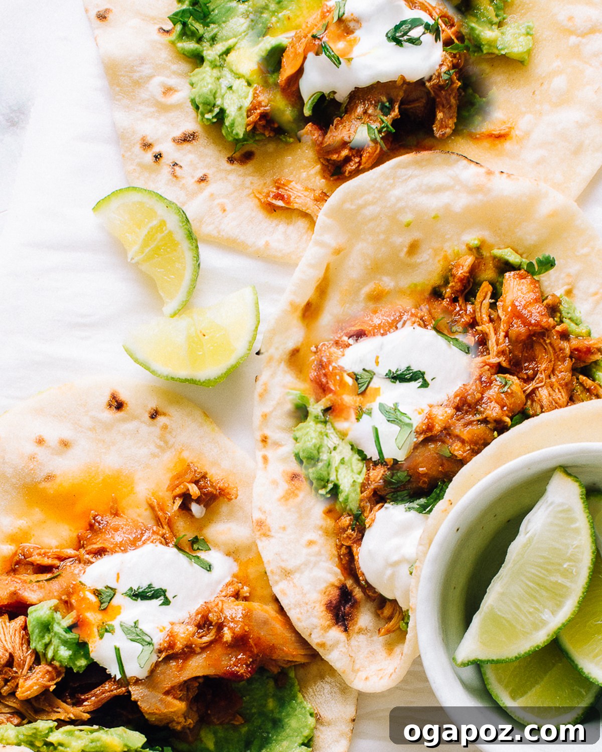 Shredded crockpot chicken tacos loaded into corn tortillas.