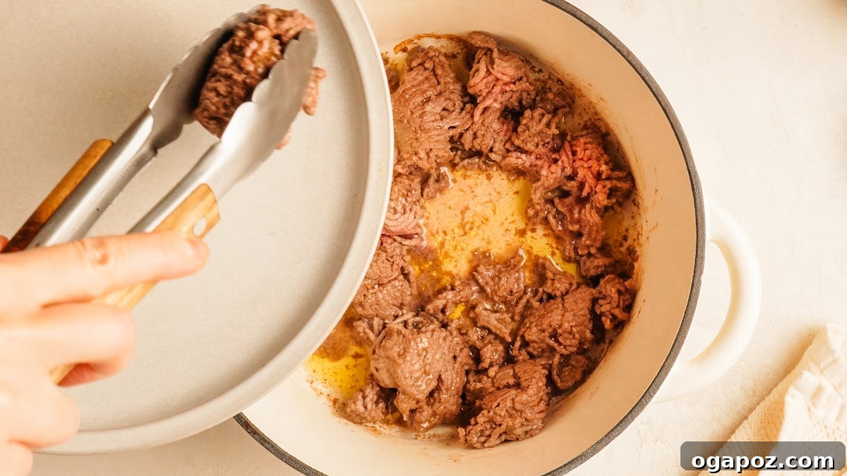 Loaded Cheesy Pizza Bowl Recipe for Weeknight Dinner 4 Step 1: ground beef browned in a Dutch oven for pizza bowls.